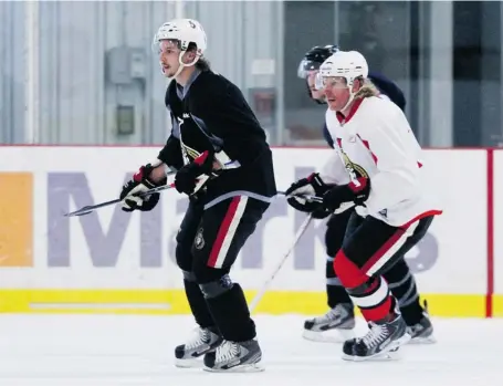  ?? JANA CHYTILOVA/OTTAWA CITIZEN ?? Erik Karlsson and Daniel Alfredsson skate at the Sensplex, Monday. While many were watching Karlsson closely in light of his Achilles tendon injury last spring, Alfredsson, now a Detroit Red Wing, raised eyebrows and had some fans grumbling over his...