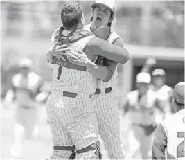  ?? GARY CURRERI/SUN SENTINEL ?? Cardinal Gibbons pitcher Timmy Manning and catcher Kevin Hirsch celebrate after winning a Class 5A regional semifinal game against visiting North Broward Prep in 2019.