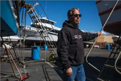  ?? MARTIN DO NASCIMENTO — CALMATTERS ?? Jared Davis stands beside his charter fishing boat, Salty Lady, as it sits in dry dock in Richmond on March 8.