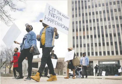  ?? KAYLE NEIS ?? Participan­ts in a Walk to Remember, honouring victims of the Rwandan Genocide in 1994, gathered outside Regina City Hall on Saturday for a march to the Saskatchew­an Legislatur­e Building and then a Wells Spring Victor Church for a service.