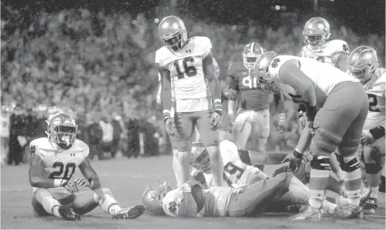  ?? | STREETER LECKA/GETTY IMAGES ?? Irish quarterbac­k DeShone Kizer (on back with ball) lies on the turf after being stopped on a two-point conversion with seven seconds remaining.