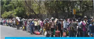  ??  ?? MUMBAI: Migrant workers queue outside the CST railway station to return to their hometowns yesterday after the government eased a nationwide lockdown. — AFP