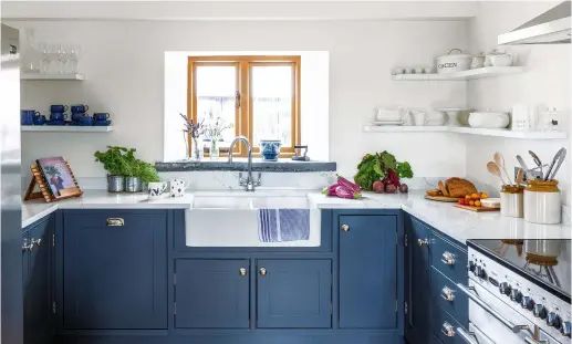  ??  ?? Above: The kitchen cabinets, painted in Mylands’ Bond Street, were made and fitted by RIG Joinery, with worktops in Carrara Venatino from Gon Granite & Marble