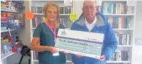  ??  ?? Bowled over George hands the cheque to May Kilpatrick