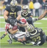  ?? Bill Feig, The Associated Press ?? Atlanta Falcons running back Devonta Freeman is tackled by the New Orleans Saints on Sunday.