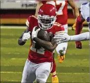  ?? ASSOCIATED PRESS PHOTOS ?? Chiefs receiver Mecole Hardman eludes a Bills tackler in the first half of Sunday’s AFC Championsh­ip Game. Hardman continued to get chances even after his muffed punt led to a Bills touchdown.