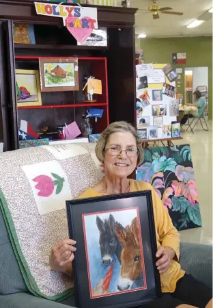  ??  ?? above Holly Anson holds a painting of the two donkeys she found in a local field. She thought they needed their portraits made.
