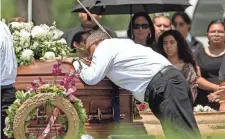  ?? JAY JANNER/ USA TODAY NETWORK ?? A mourner pauses at a casket at a funeral last week for a mass shooting victim in Uvalde, Texas.
