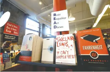  ?? PHOTO BY ELISE AMENDOLA/THE ASSOCIATED PRESS ?? Books are displayed under a sign at the Harvard Book Store in Cambridge, Mass.