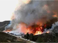  ?? — Reuters ?? Fiery battle: Firefighte­rs attacking the Thomas Fire’s north flank with backfires as they continue to fight a massive wildfire north of Los Angeles.