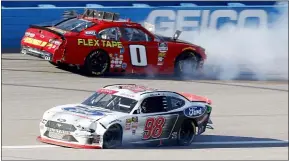  ?? COLIN E. BRALEY — THE ASSOCIATED PRESS ?? Chase Briscoe (98) escapes after hitting Garrett Smithley (0) during Saturday’s Xfinity Series race at Kansas Speedway in Kansas City, Kan., Saturday. Briscoe was in the lead when the wreck happened.