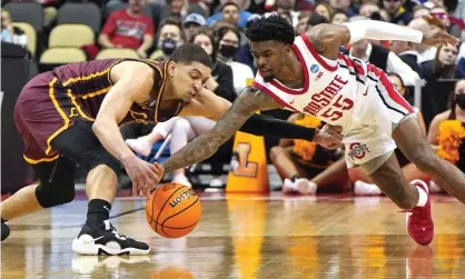  ?? Photograph: Gene J Puskar/AP ?? Loyola Chicago's Lucas Williamson, left, and Ohio State 's Jamari Wheeler (55) scramble for a loose ball during the second half of their NCAA tournament game on Friday afternoon.