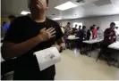  ??  ?? Immigrants say the Pledge of Allegiance in a writing class at the Carrizo Springs holding center in Texas. Photograph: Eric