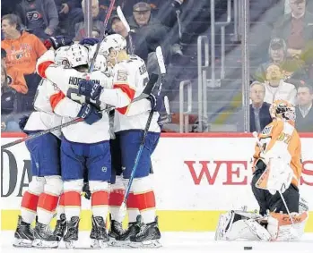  ?? PATRICK SMITH/GETTY ?? The Panthers’ Aaron Ekblad celebrates with teammates after his goal against the Flyers on Tuesday in Philadelph­ia.