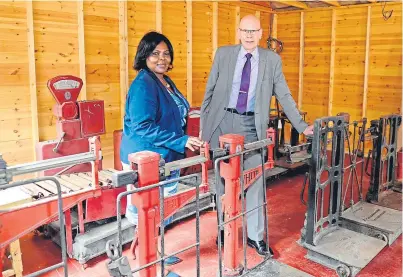  ?? Pictures: George Mcluskie. ?? Top: Joyce Onuonga, managing director of John White & Son. Above: Joyce with Edwin White beside a variety of weighing machines from the firm’s past.