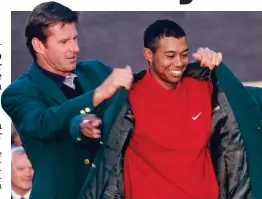  ?? GETTY IMAGES ?? Suits you: Faldo puts the green jacket on Woods at the 1997 Masters