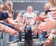  ?? Team IMPACT ?? Daniela Ciriello is pictured with the 2019-20 UConn women’s team. Ciriello, who suffers from a genetic blood disorder, was named a member of the team two years ago.