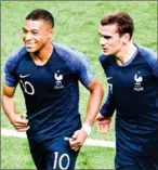  ?? AFP ?? France’s Kylian Mbappe (left) celebrates with Antoine Griezmann after scoring in the World Cup final on July 15.