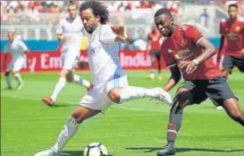  ?? AFP ?? Real Madrid’s Marcelo Da Silva (L) and Manchester United’s Timothy FosuMensah vie for the ball during their Internatio­nal Champions Cup match at Levi's Stadium in Santa Clara on Sunday.