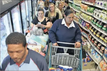  ??  ?? Checkers store customers in Sea Point, Cape Town. South African consumers continued to be under pressure in the second quarter of this year, the consumer confidence index shows.