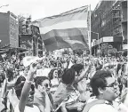  ?? ALBA VIGARAY/EPA-EFE ?? People march in the New York City Gay Pride Parade in June. More cities are taking actions that are inclusive to the LGBTQ community.