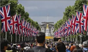  ?? MATT DUNHAM/ASSOCIATED PRESS ?? Union Jacks line the mall in front of Buckingham Palace on Tuesday, two days before the start of Queen Elizabeth II’S Platinum Jubilee, celebratin­g her 70 years on the throne. Elizabeth became queen in February 1952 and was only 27 at the time of her official coronation in June 1953. Millions around the world watched the BBC telecast from Wesminster Abbey.