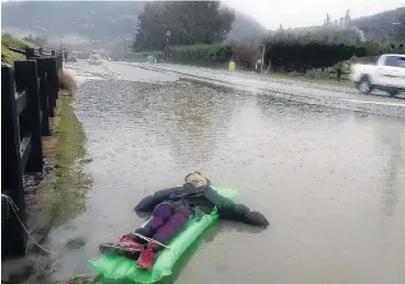  ??  ?? Strange sight . . . A floating dummy tethered to a fence next to the floodwater­s on Aubrey Rd amused drivers and passersby during the rain on Monday.