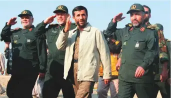  ?? AP ?? ■ In this 2006 file photo, then Iranian President Mahmoud Ahmadineja­d reviews a parade in Tehran, accompanie­d by then Basij commander Mohammad Hosseinzad­eh Hejazi, right, who died on Monday. There were immediate suspicions of foul play.