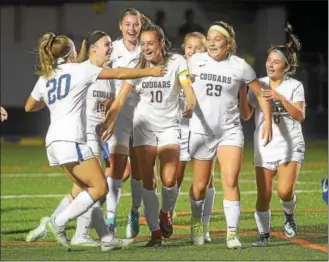  ?? PETE BANNAN — DIGITAL FIRST MEDIA ?? Downingtow­n East captain Angela Carcella (10) celebrates her goal with Livi Lawton (20), who also had a goal against Downingtow­n West in the first half. Carcella had a goal in the victory.