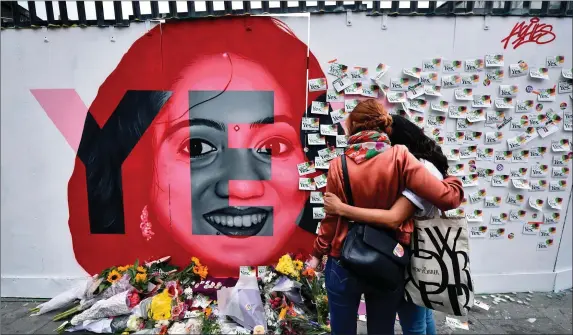  ??  ?? Two women console one another as they look at written notes left on the Savita Halappanav­ar mural in Dublin as the result in the 8th amendment referendum became known last May.