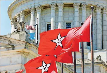  ?? [PHOTO BY JIM BECKEL, THE OKLAHOMAN] ?? In honor of the state Capitol’s centennial, Oklahoma’s original flag will fly outside of the Capitol for the next two weeks. The red banner with the number 46 inside a white star was the state’s first flag. It flew 14 years until 1925, when the state...