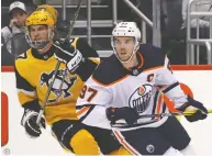  ?? GENE J. PUSKAR / THE ASSOCIATED PRESS FILES ?? Stars Connor McDavid of the Oilers and the Penguins' Sidney Crosby have both been supportive of the coming-out revelation­s of CAA agent Bayne Pettinger.