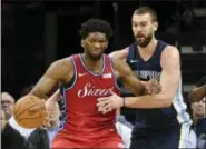  ?? BRANDON DILL — THE ASSOCIATED PRESS ?? Philadelph­ia 76ers center Joel Embiid, left, controls the ball against Memphis Grizzlies center Marc Gasol in the first half of Monday’s game in Memphis, Tenn.