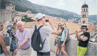  ??  ?? Tourists in Dubrovnik, Croatia, on the old town fortress wall, which appears in the hit show Game of Thrones. Officials in Dubrovnik are starting to push back against the throngs of tourists in an attempt to find the right balance of welcoming them.