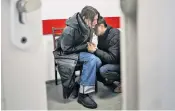  ?? ?? Doctors work to save the life of 18-month-old Kirill Yatsko but his injuries were too great. His mother, Marina, is consoled, above
