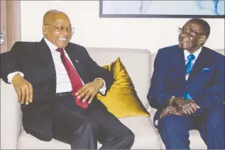  ??  ?? President Mugabe shares a lighter moment with his South African counterpar­t President Jacob Zuma on the sidelines of the World Economic Forum on Africa in Durban, South Africa, yesterday. — (Picture by Manfred Takaendesa)