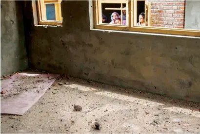  ?? AP ?? Unexploded grenades lie on the floor of a house, where suspected rebels were holed up, after a gun battle in Srinagar on Saturday. —