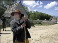  ?? CHITOSE SUZUKI — THE ASSOCIATED PRESS FILE ?? A 17th-century costumed role player, who called himself Samuel Fuller, poses in a 1627 Pilgrim Village at Plimoth Plantation in Plymouth, Mass.