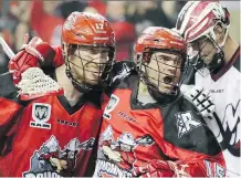  ?? GAVIN YOUNG/ CALGARY HERALD ?? Curtis Dickson, left, celebrates a goal by Shawn Evans against Colorado last Saturday. As the Riggers push for the playoffs, Evans is gunning for the NLL single season scoring record.