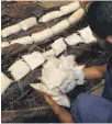  ??  ?? A Dubai customs officer with confiscate­d drugs