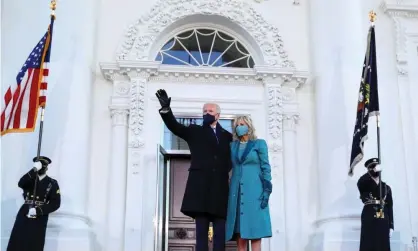  ??  ?? Joe Biden waves next to the first lady, Dr Jill Biden, as they stand at the North Portico of the White House on 20 January. Photograph: Tom Brenner/Reuters