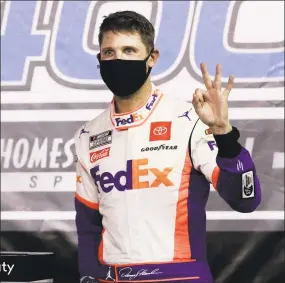  ?? Wilfredo Lee / Associated Press ?? Denny Hamlin celebrates after winning Sunday night in Homestead, Fla.