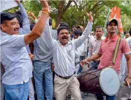  ?? — PTI ?? Congress party workers celebrate in New Delhi on Saturday after Karnataka chief minister B. S. Yeddyurapp­a announced his resignatio­n before a trust vote.