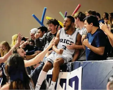  ?? Karen Warren/Staff photograph­er ?? Rice guard Travis Evee jumps into the stands with fans as they celebrated his game-winning shot at the buzzer that lifted the Owls past UTEP on Saturday at Tudor Fieldhouse.