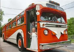 ?? Haldan Kirsch/Post-Gazette ?? Ansley Collins disembarks from a 1957 GMC bus used by Antique Coach Excursions to transport a bridal party.