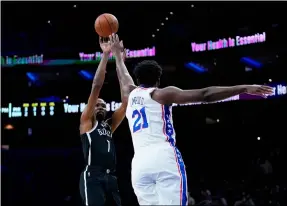  ?? MATT SLOCUM — THE ASSOCIATED PRESS ?? The Nets’ Kevin Durant, left, goes up for a shot against the 76ers’ Joel Embiid during the first half Oct. 11in Philadelph­ia.