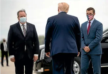  ??  ?? President Donald Trump is greeted by Kurt Heise, left, Supervisor of Plymouth Township, Michigan, and Speaker Lee Chatfield, of the Michigan House of Representa­tives, at Detroit Metro Airport on May 21. Trump summoned Chatfield and Michigan Senate Majority Leader Mike Shirkey to the White House for a meeting on Friday.