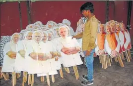  ?? MANOJ DHAKA/HT ?? A worker in Rohtak walks past cutouts of Prime Minister Narendra Modi and BJP national president Amit Shah ahead of Shah’s 3day visit to Haryana; (right) a drone inspecting the area where the BJP leader will stay in Rohtak.