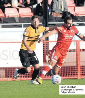  ??  ?? Josh Sheehan challenges Crawley’s Felipe Morais