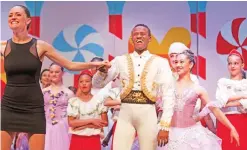  ??  ?? Dance Centre Kenya’s artistic director Cooper Rust, left, from the United States, holds the hand of Kenyan ballet dancer Joel Kioko, 16, center, as they take a bow at the end of a performanc­e of The Nutcracker in Nairobi, Kenya.